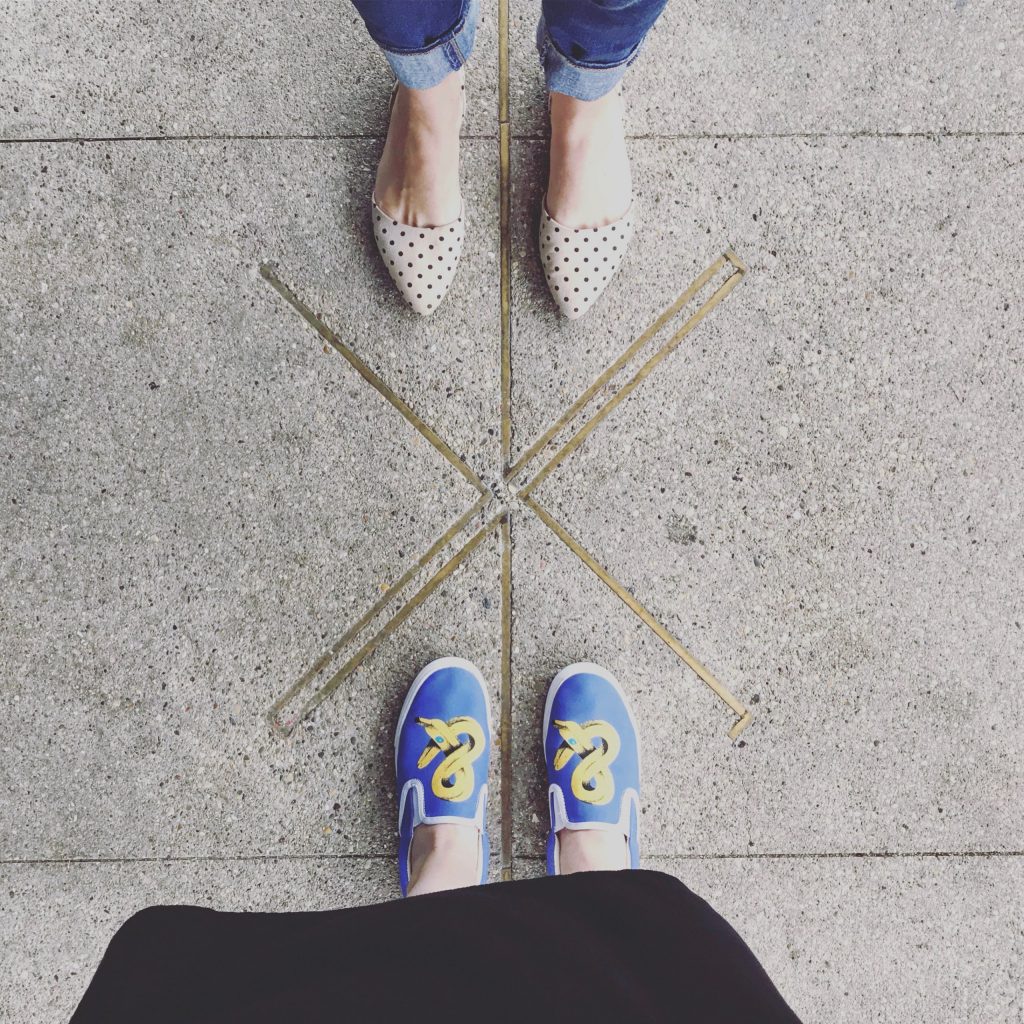 Faith and Stacy's shoes as they stand across from each other