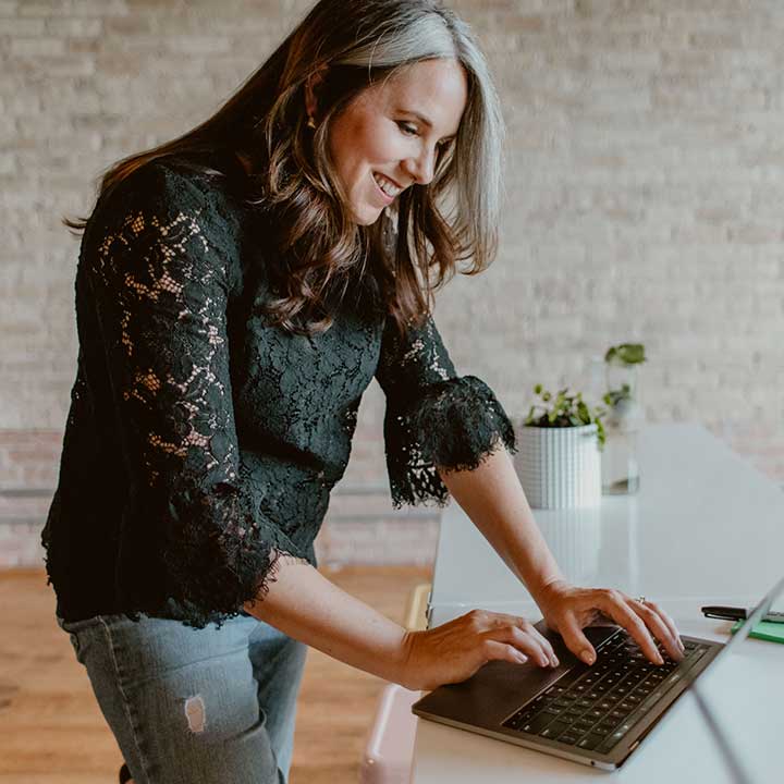 Our co-founder Faith smiling while chatting with a client on a conference call.